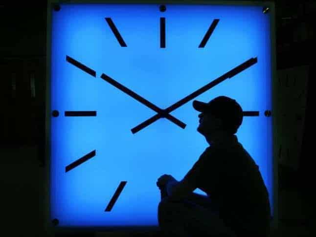 Electric Time Company employee Dan Lamoore adjusts the color on a 67-inch square LED color