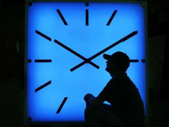 Electric Time Company employee Dan Lamoore adjusts the color on a 67-inch square LED color